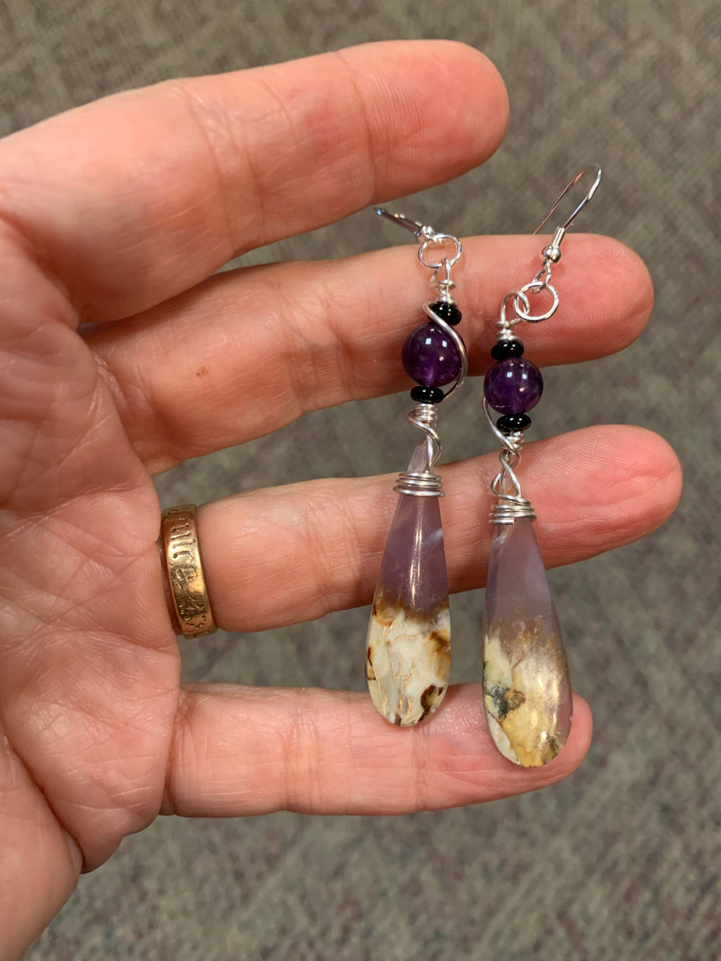 Winter Polychrome Amethyst earrings held in hand