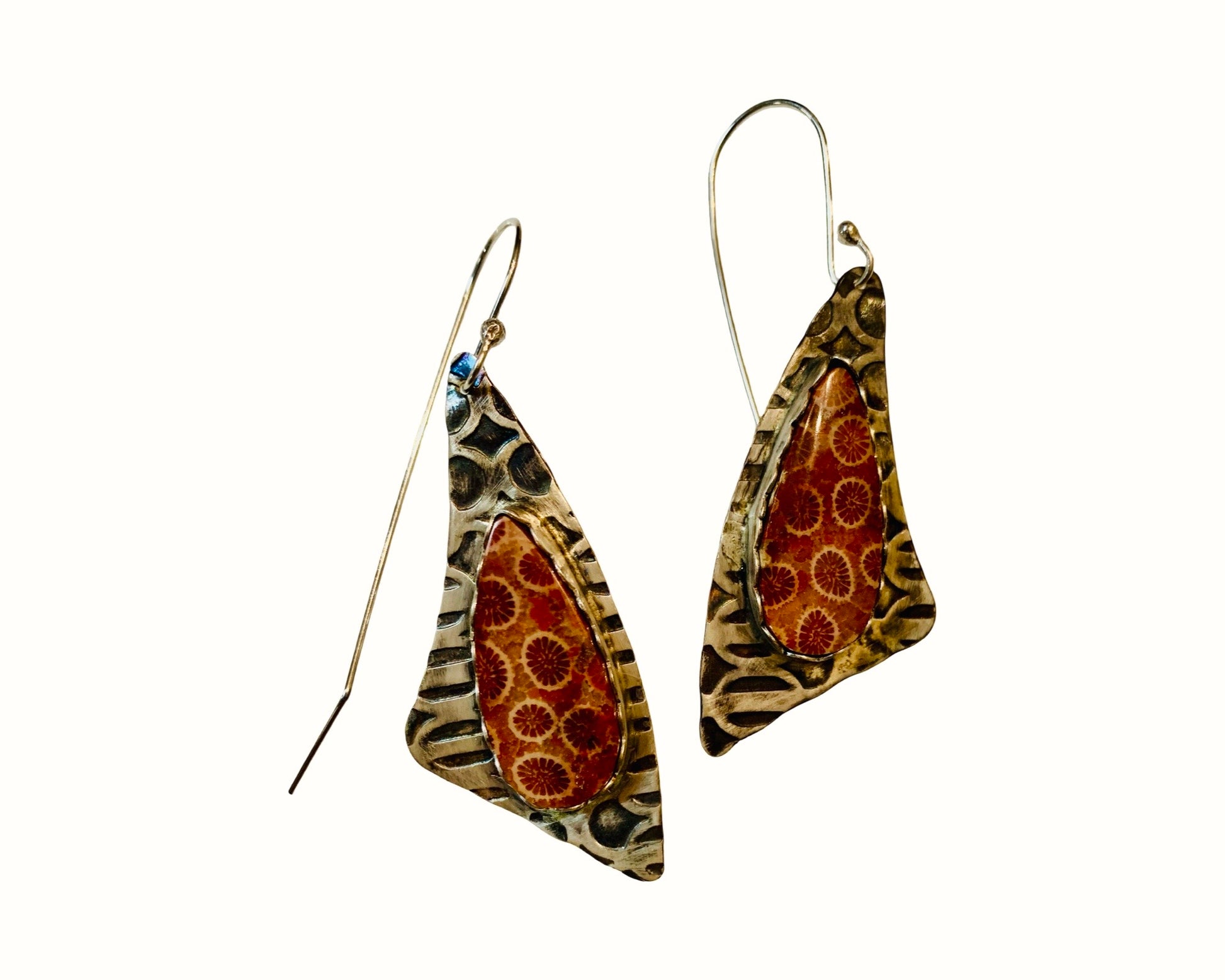 Pair of earrings with fossil coral geometric design on a white background