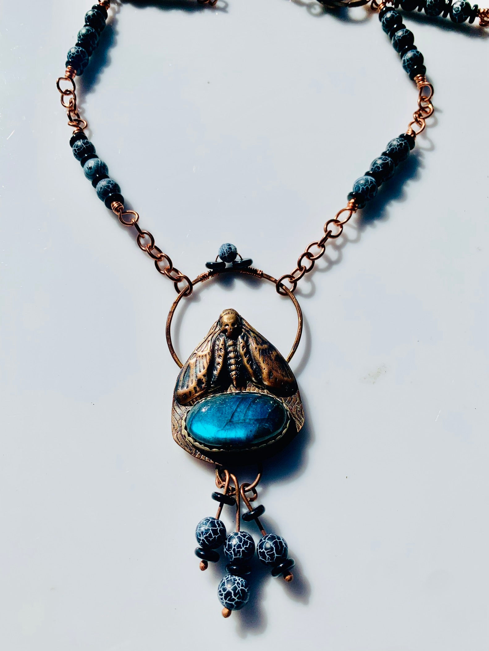 Deadhead moth pendant necklace with blue stone