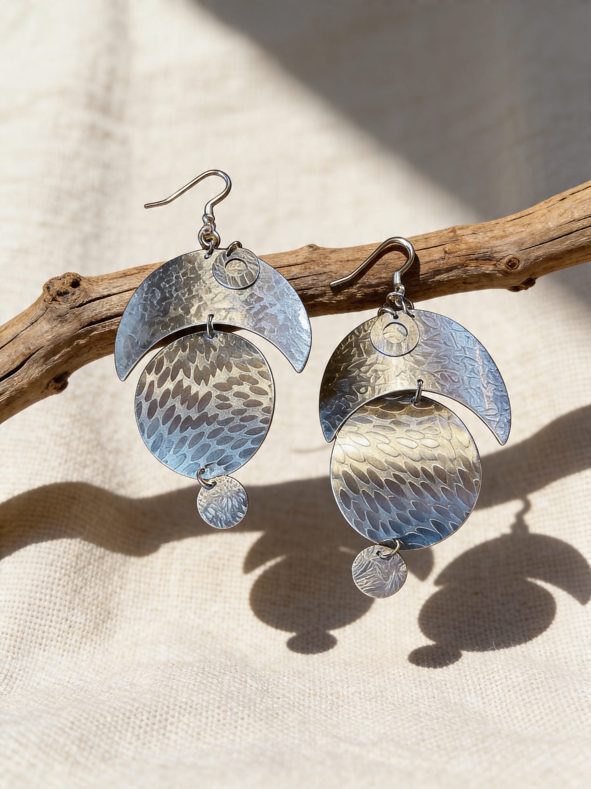 Handcrafted aluminum moon and circle statement earrings with textured metal design