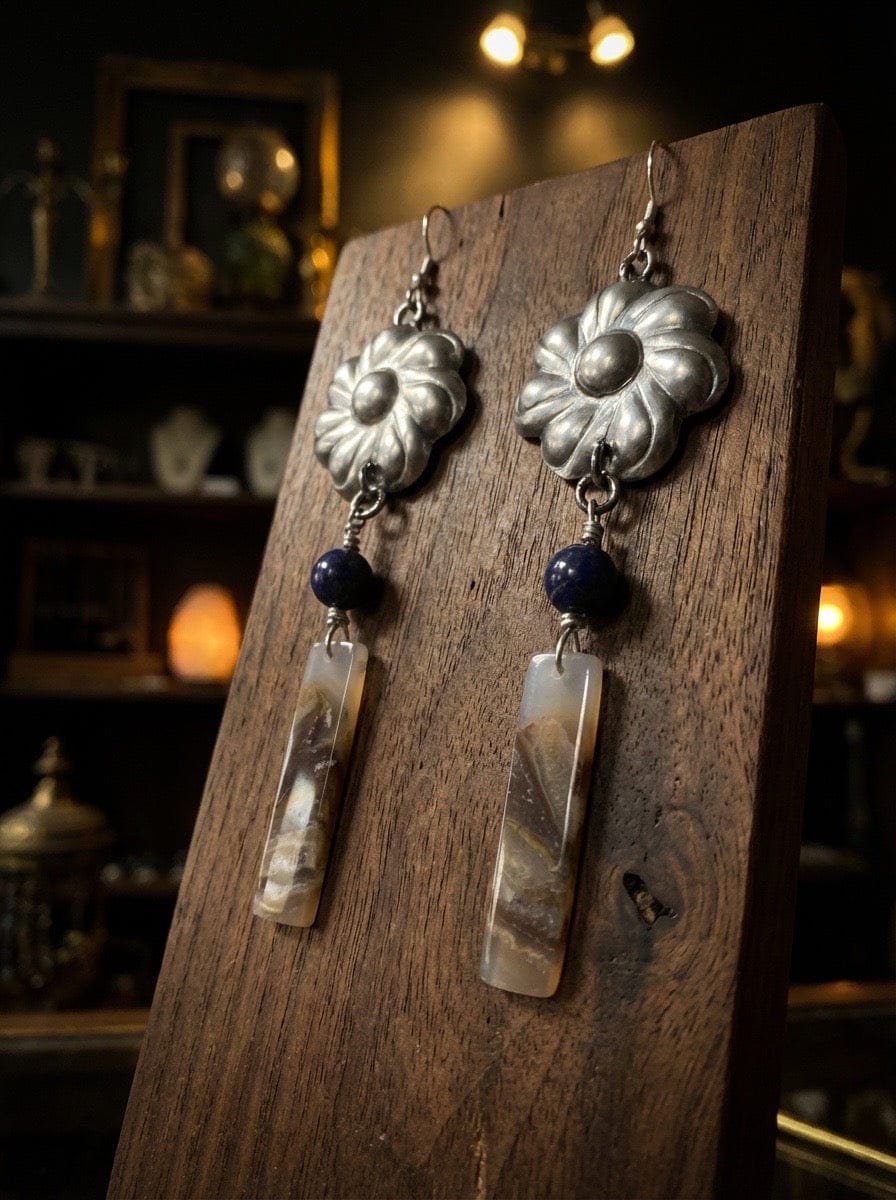Flowers pressed in aluminum with jasper drops on a wooden display